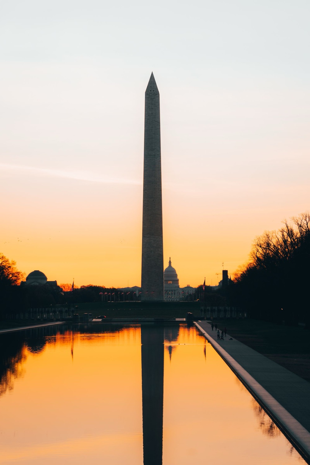 The Washington Monument at golden sunset reflected in the pool, Washington, DC